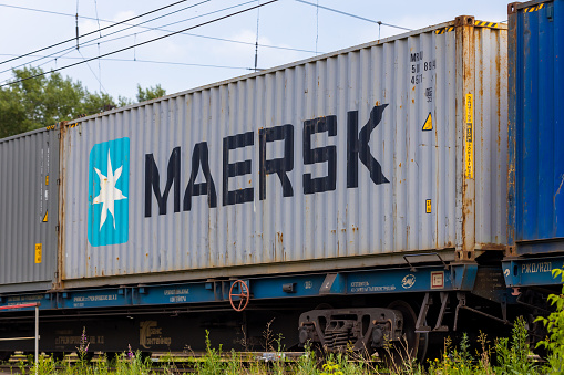 Krasnoyarsk, Russia - June 23, 2022: Close-up Maersk industrial cargo freight wagon on railroad. Maersk inscription on a railroad container