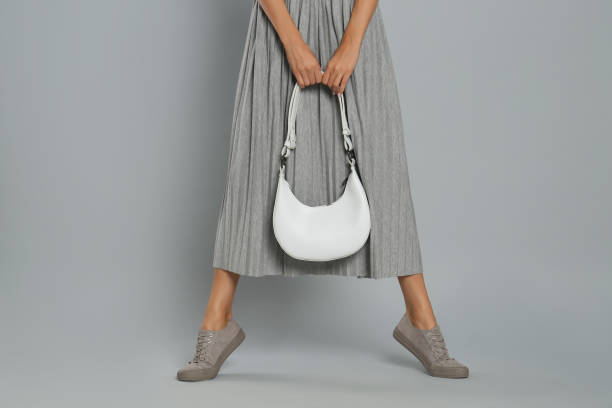 istock Woman with stylish bag on grey background, closeup 1404893601