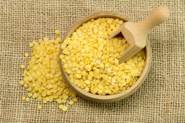istock Yellow Lentils, wooden cup and spoon 1404895779