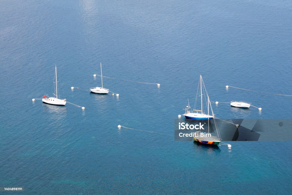 Five Sailboats Moored on Mediterranean Sea, Cap-d’Ail, Cote d'Azur, French Riviera Five sailboats moored on Mediterranean Sea, Cap-d’Ail, Cote d'Azur, French Riviera, Europe. Blue Stock Photo