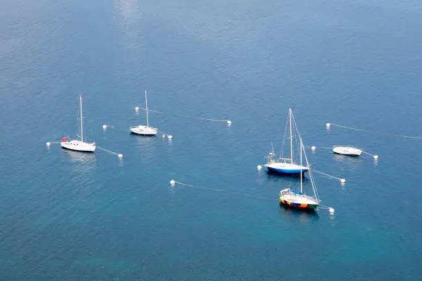 Five sailboats moored on Mediterranean Sea, Cap-d’Ail, Cote d'Azur, French Riviera, Europe.
