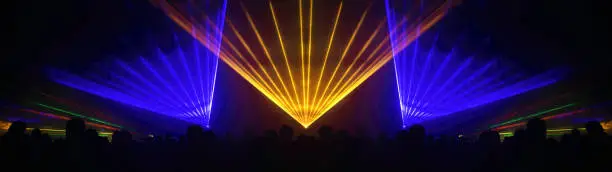 Lasershow festival disco  party background banner panorama - Colorful outdoor laser show with rays streams and crowd silhouette of party people