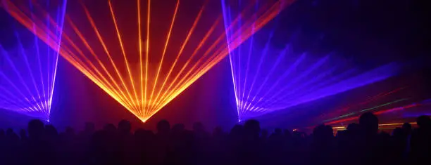 Lasershow festival disco  party background banner panorama - Colorful outdoor laser show with rays streams and crowd silhouette of party people