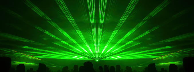 Lasershow festival disco  party background banner panorama - Colorful outdoor laser show with rays streams and crowd silhouette of party people