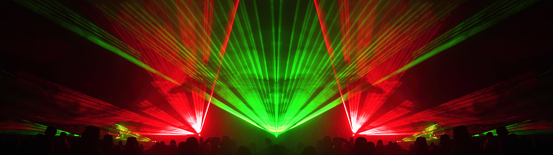 Laser show at generic party night club with bright spotlight on disco ball - Nightlife reopening concept about music and entertainment - Image with powered colored halos and vivid glowing lights
