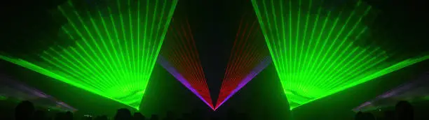 Lasershow festival disco  party background banner panorama - Colorful outdoor laser show with rays streams and crowd silhouette of party people