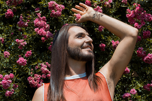 Handsome man with long hair posing outdoors