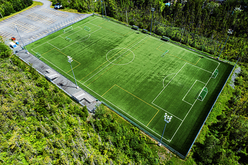 Aerial drone view of an empty soccer field on a Summer afternoon.