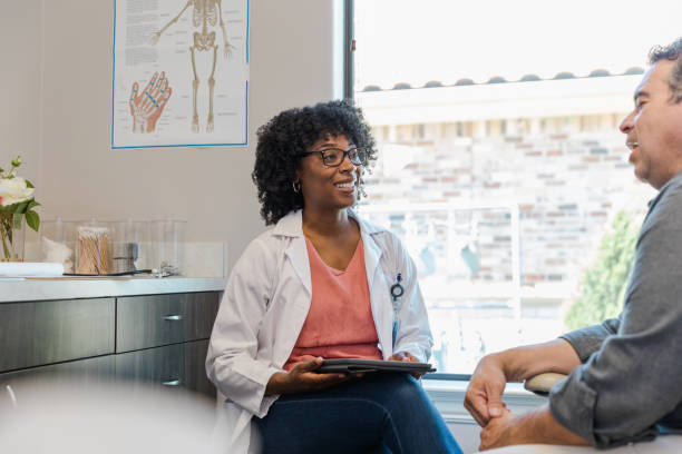 istock Doctor listens and smiles while her patient talks 1404901761