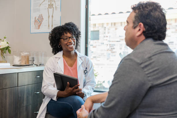 istock Physical therapist meets with male patient 1404901770