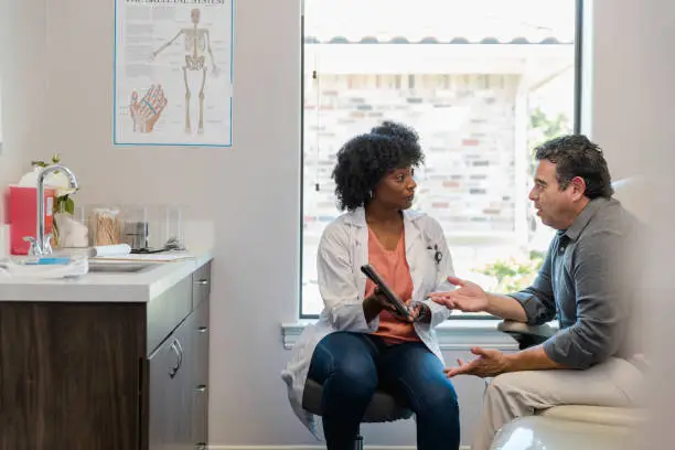 The medical billing coordinator meets with the patient to discuss payment options for his upcoming procedure.