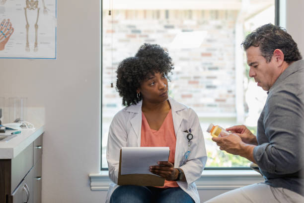 istock Doctor listens seriously to patient concerns about drug side effects 1404901820
