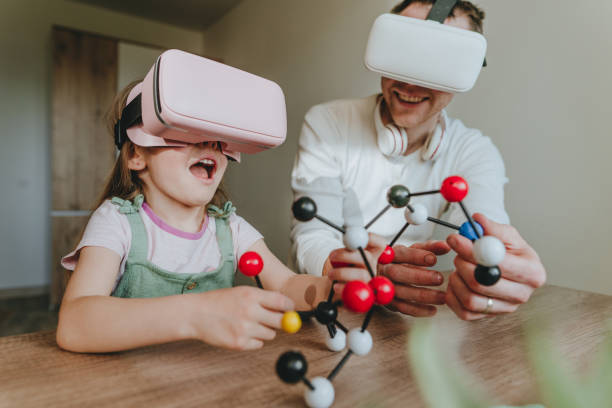 istock Little girl having fun time with her father using VR glasses 1404904553