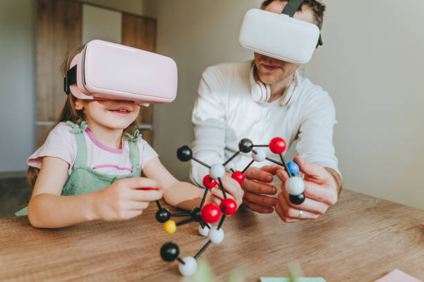 istock Little girl having fun time with her father using VR glasses 1404904554