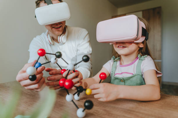 istock Little girl having fun time with her father using VR glasses 1404904559