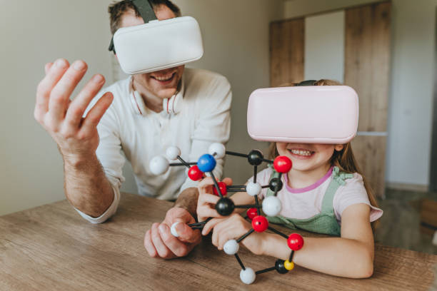istock Little girl having fun time with her father using VR glasses 1404904577