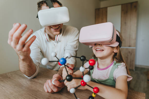 istock Little girl having fun time with her father using VR glasses 1404904578