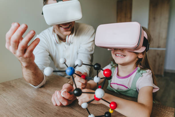 istock Little girl having fun time with her father using VR glasses 1404904582