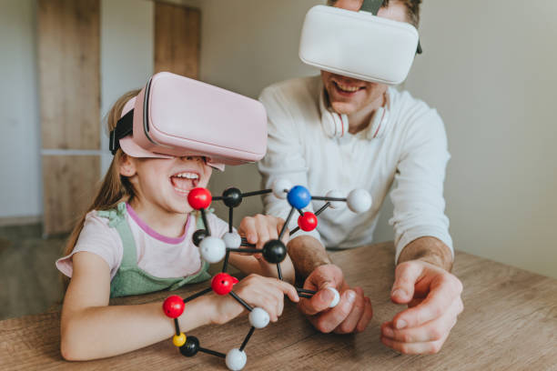 istock Little girl having fun time with her father using VR glasses 1404904608