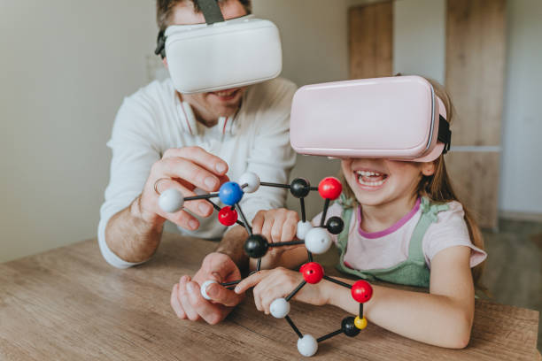istock Little girl having fun time with her father using VR glasses 1404904617