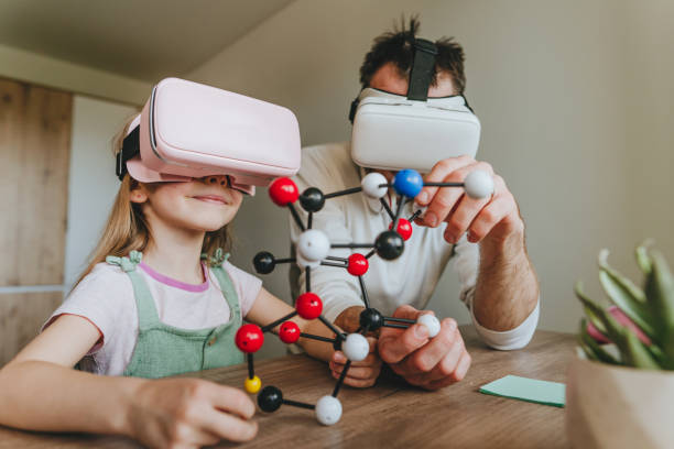 istock Little girl having fun time with her father using VR glasses 1404904624