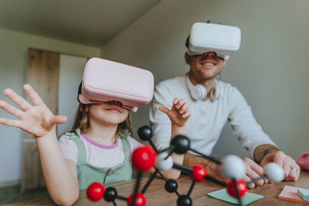 istock Little girl having fun time with her father using VR glasses 1404904660