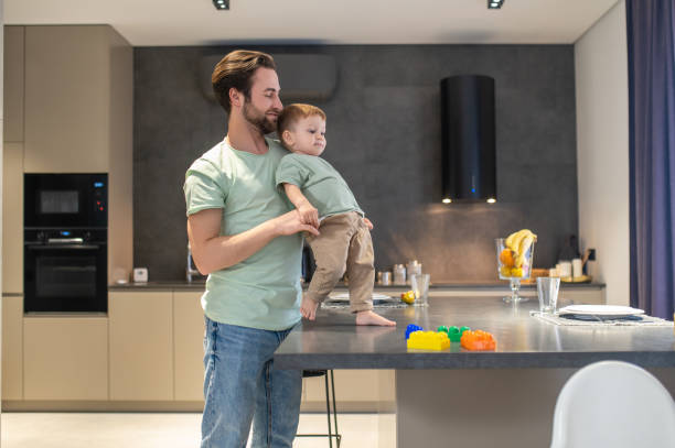 istock Dad and son looking happy spending time together 1404906573