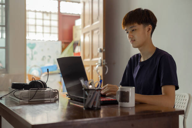 istock An asian chinese teenager  doing his homework at the kitchen dining table 1404909037