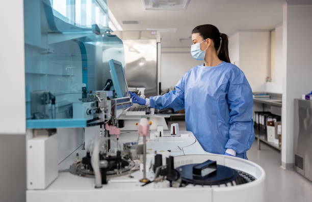 Doctor working in a medical laboratory processing blood tests Latin American female doctor working in a medical laboratory at the hospital processing blood tests human centrifuge stock pictures, royalty-free photos & images