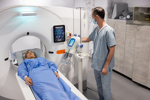 Latin American woman getting an MRI scan at the hospital - healthcare and medicine concepts