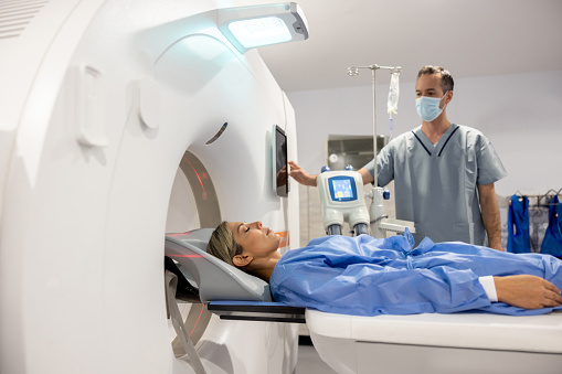 Latin American woman getting an MRI scan at the hospital - healthcare and medicine concepts