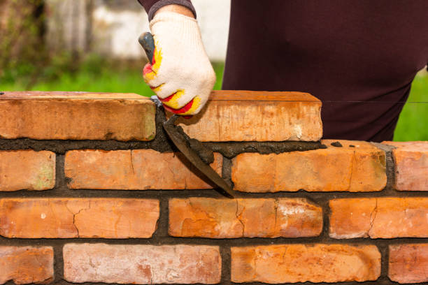 istock a man's hand with a construction trowel removes excess cement mortar from the brickwork during the construction of the wall 1404912785