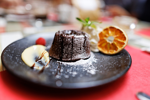 Closeup of chocolate cake dessert on decorated plate.\nCanon R5