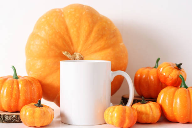 istock White coffee mug and many pumprins fall mockup. 1404913688