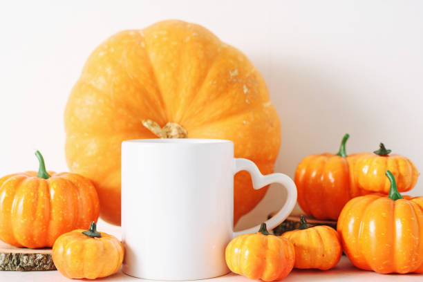istock White coffee mug and many pumprins fall mockup. 1404913698