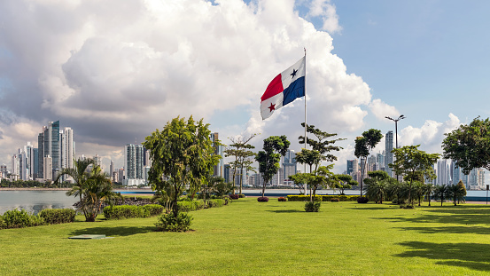 Panama City, Panama - October 29, 2021: Monument of the Flag of Panama and the skyscrapers by the shores of Panama Bay in Panama City.