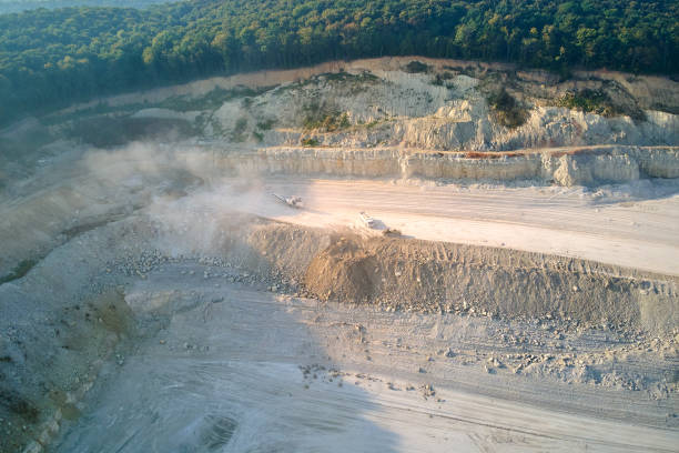istock Aerial view of open pit mining site of limestone materials extraction for construction industry with excavators and dump trucks. 1404922401