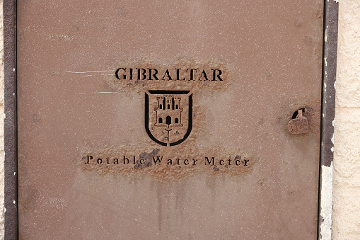 16th June 2022: Gibraltar logo laser carved or die cut into a metal panel covering a water meter