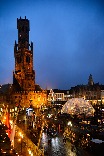 Bruges, Belgium - December 27, 2021: Markt square decorated and illuminated for Christmas with Belfort and Christmas market.