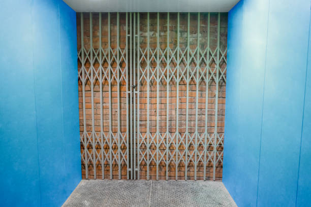 cabin of an old freight elevator - lock door horror gate imagens e fotografias de stock