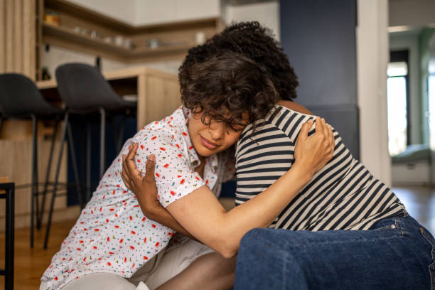 istock Two friends sharing a hard moment by hugging 1404927277