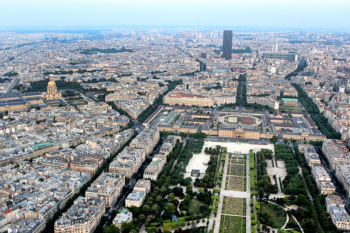 Aerial View of the Seine River flowing through Paris with the historic district in the foreground including the Grand Palais des Champs-Élysées, and the commercial & financial district in the distance as seen from the Eiffel Tower
