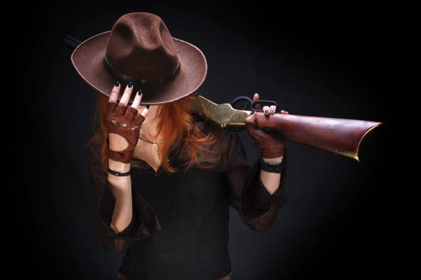 istock wild west girl with rifle 1404942624