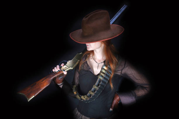 istock wild west girl with rifle 1404942647