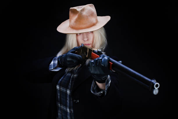 wild west blonde girl with rifle on black background