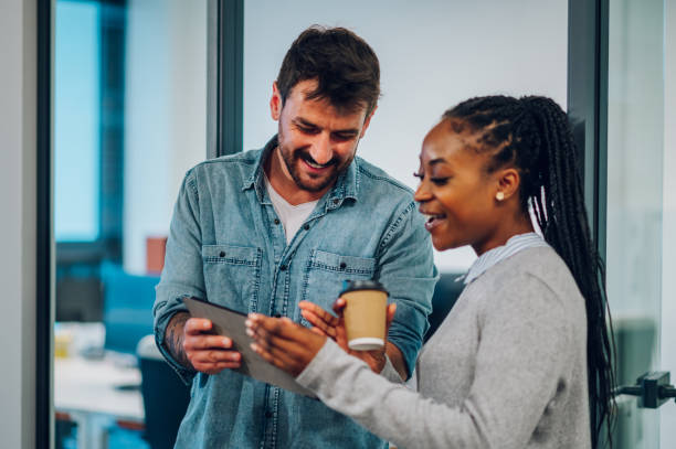 istock Two multiracial business colleagues working together on a digital tablet 1404944781