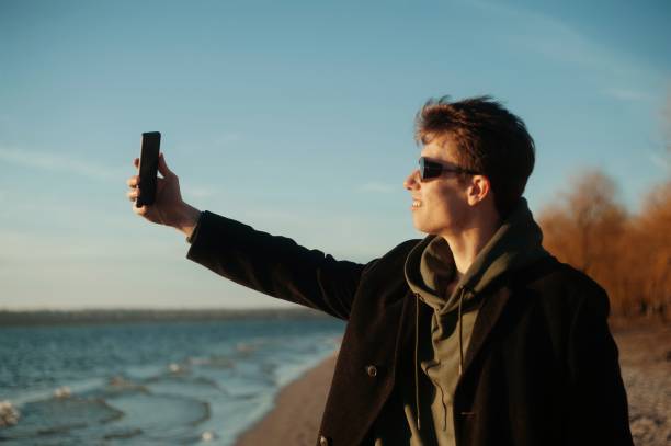 istock Young man making selfie on the beach 1404946903