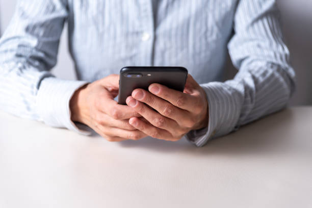 istock hands holding a cellular phone, communication concept, networks and communications, selective focus 1404951673