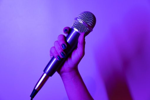 Cropped Hand Of Musician Holding Microphone