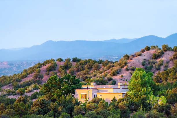 High desert mountain house home during summer sunset and twilight blue hour in Santa Fe, New Mexico High desert mountain house home during summer sunset and twilight blue hour in Santa Fe, New Mexico santa fe new mexico mountains stock pictures, royalty-free photos & images